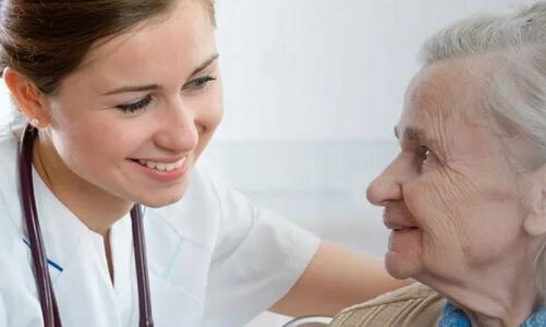 LPN to BSN Student Smiling with Elderly Patient